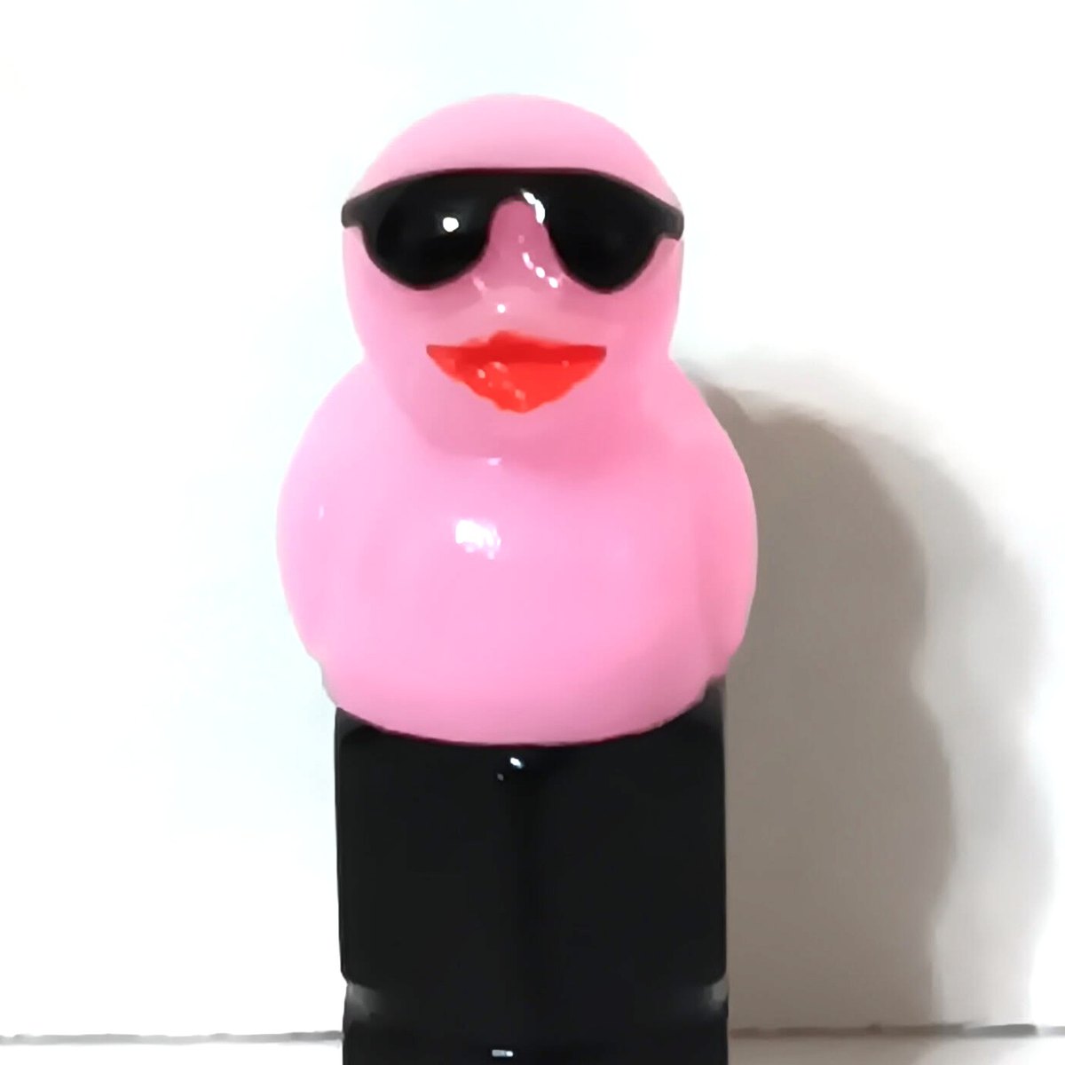 Light pink duck valve stem cap wearing tiny sunglasses