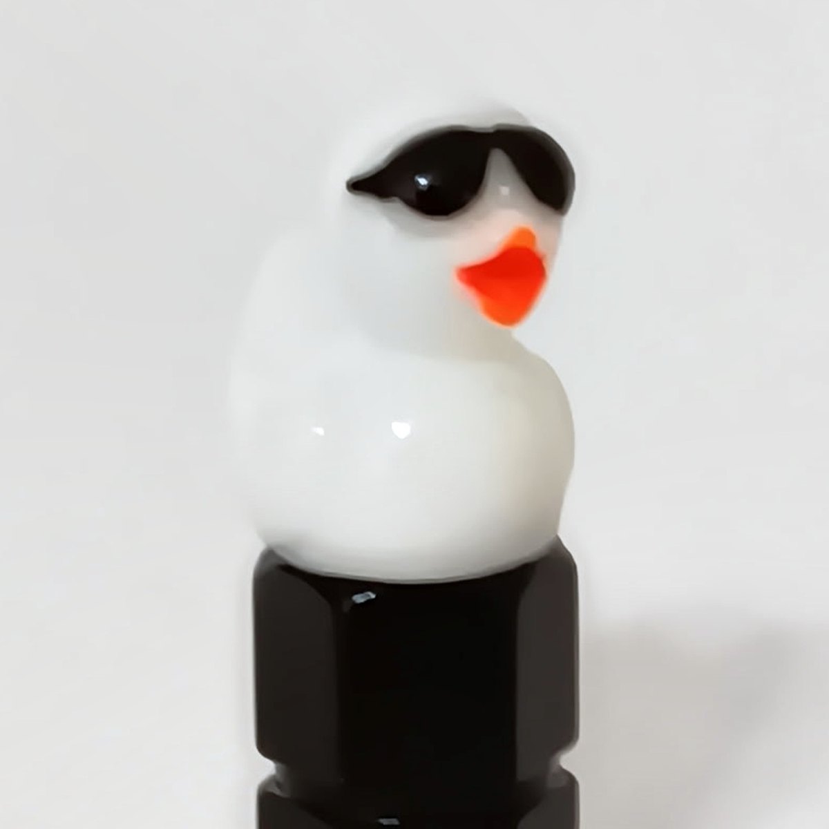 White duck valve stem cap wearing tiny sunglasses