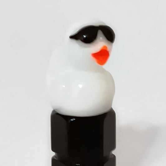 White duck valve stem cap wearing tiny sunglasses